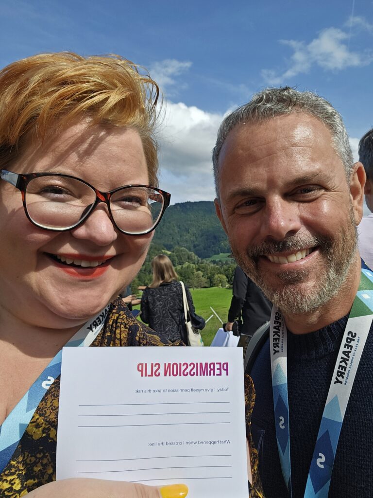 Selfie of me and Scott, a smiling American man, holding a permission slip