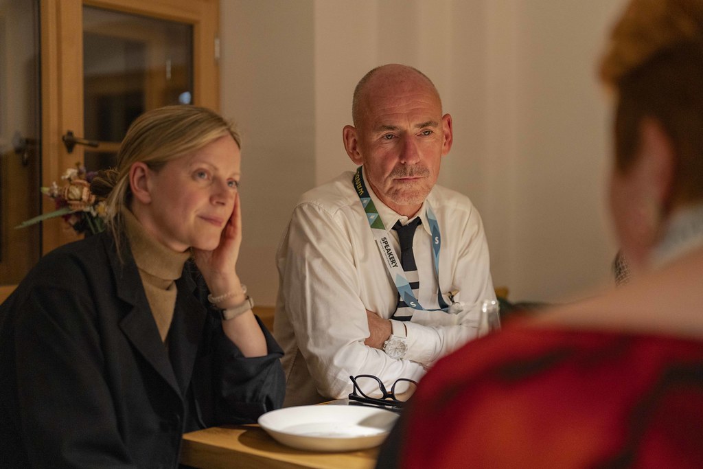 Three people talking at a table