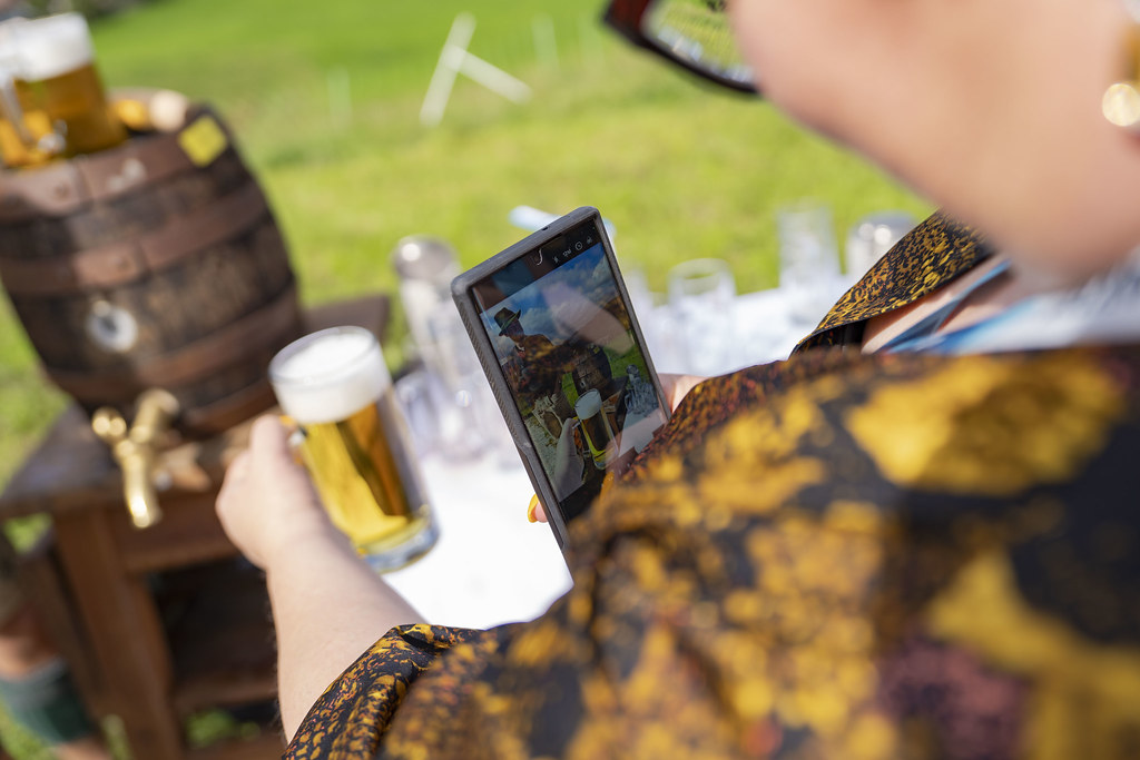 Photo of Lisa taking a selfie with a beer