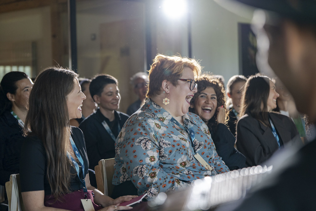 Sitting laughing in the main event audience