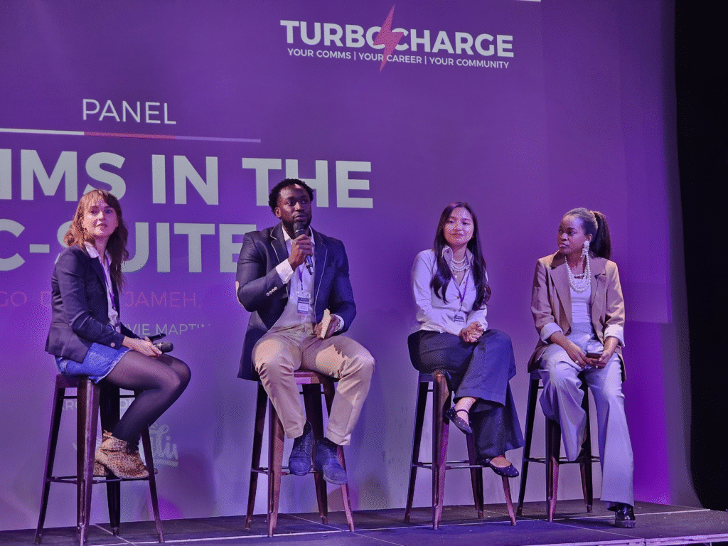 4 people sat on stools on a stage