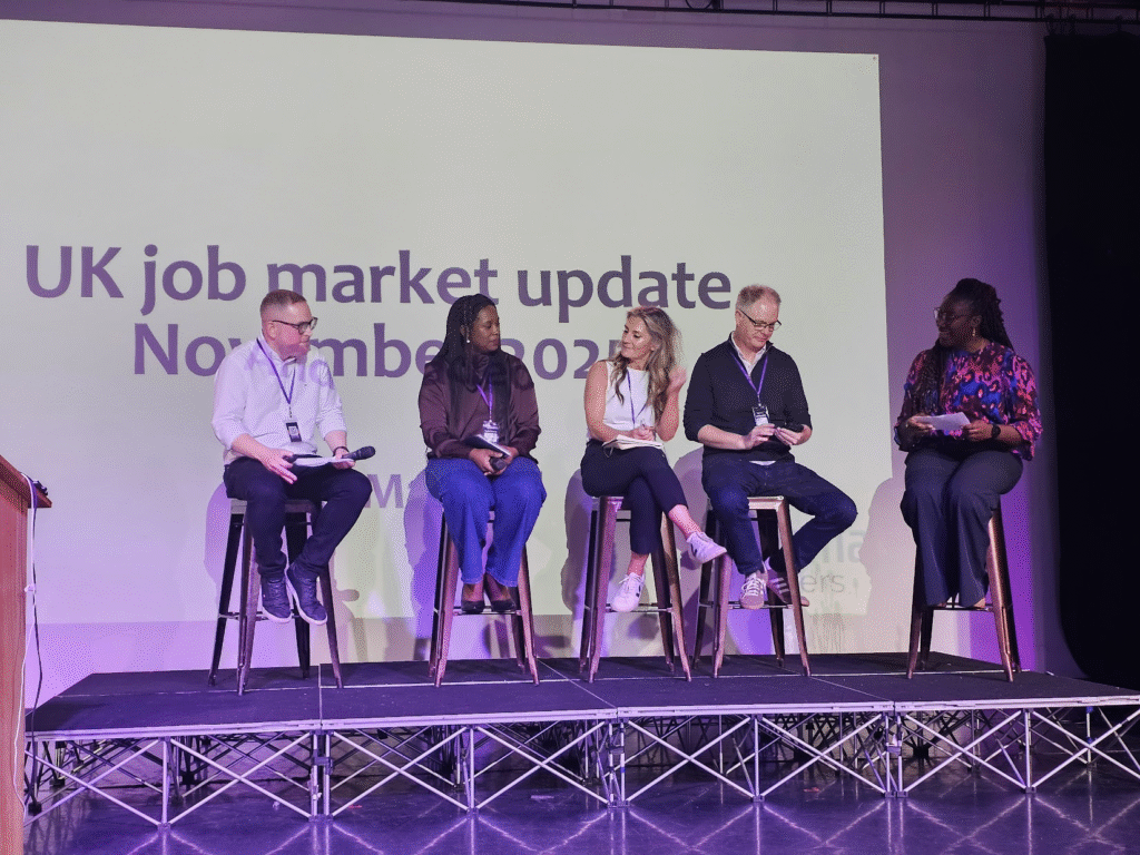 5 people sitting on stools on a stage with the title UK job market update