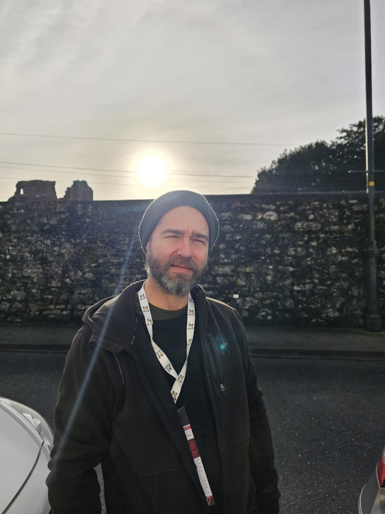 Bearded man wearing a beanie hat on a hazy morning