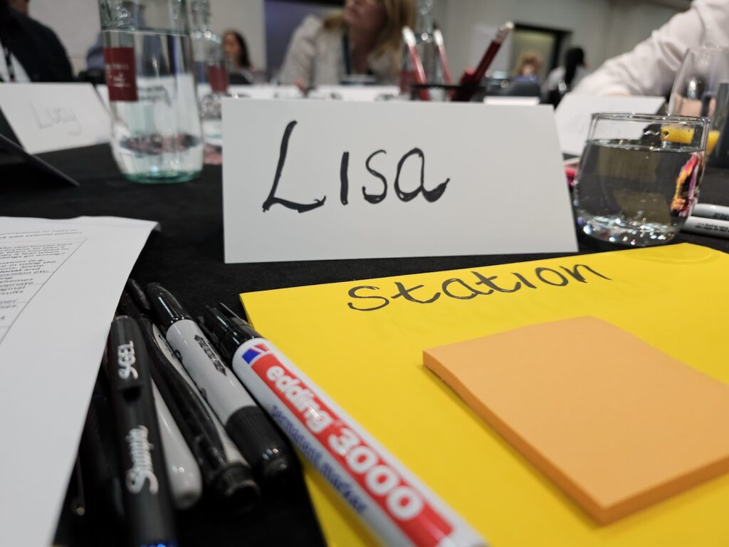 Hand-written name card on a stack of large post-it notes